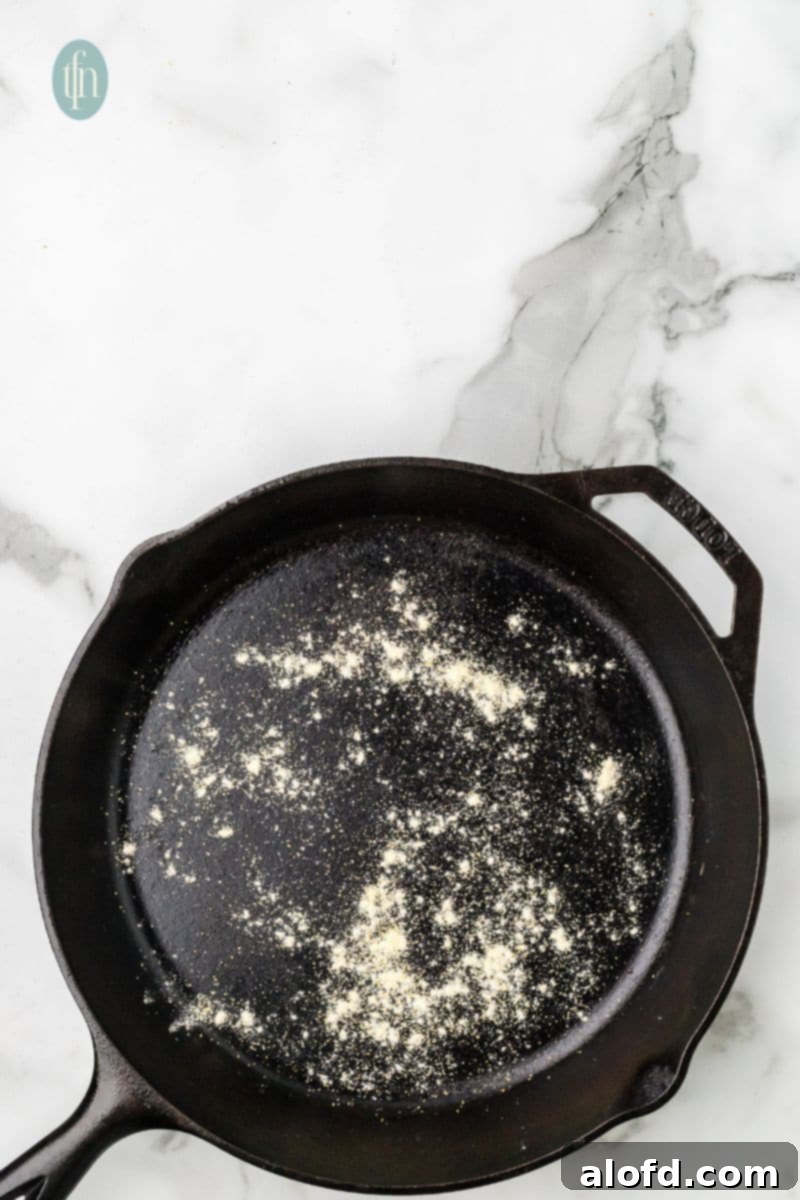 Artisan Sourdough English Muffin Bread 18 A skillet lightly sprinkled with flour, preparing for the muffins.