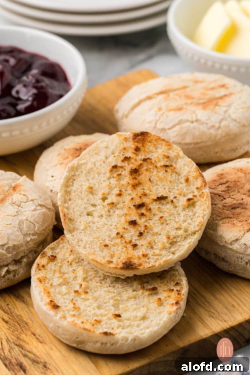 Artisan Sourdough English Muffin Bread 3 A beautiful array of freshly baked sourdough English muffins, stacked and ready to be served.