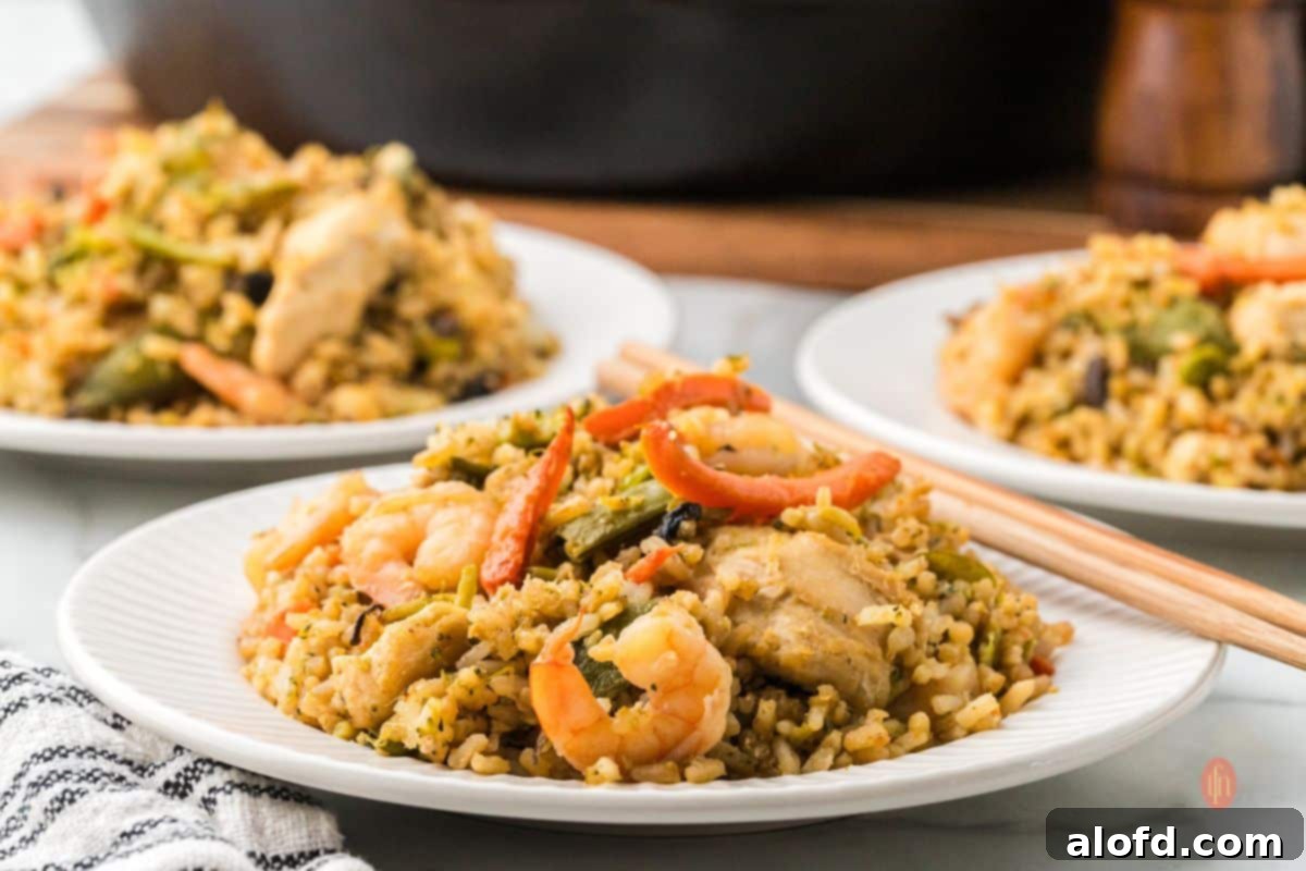 Surf and Turf Fried Rice 18 A large rectangular platter of shrimp and chicken fried rice, perfect for sharing at a family dinner.