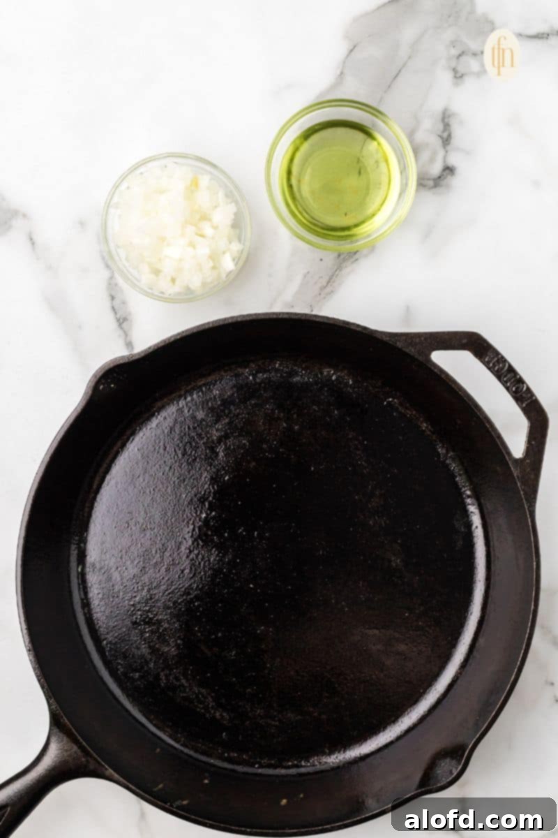 Surf and Turf Fried Rice 6 A griddle heating up with a small bowl of oil and chopped onions.