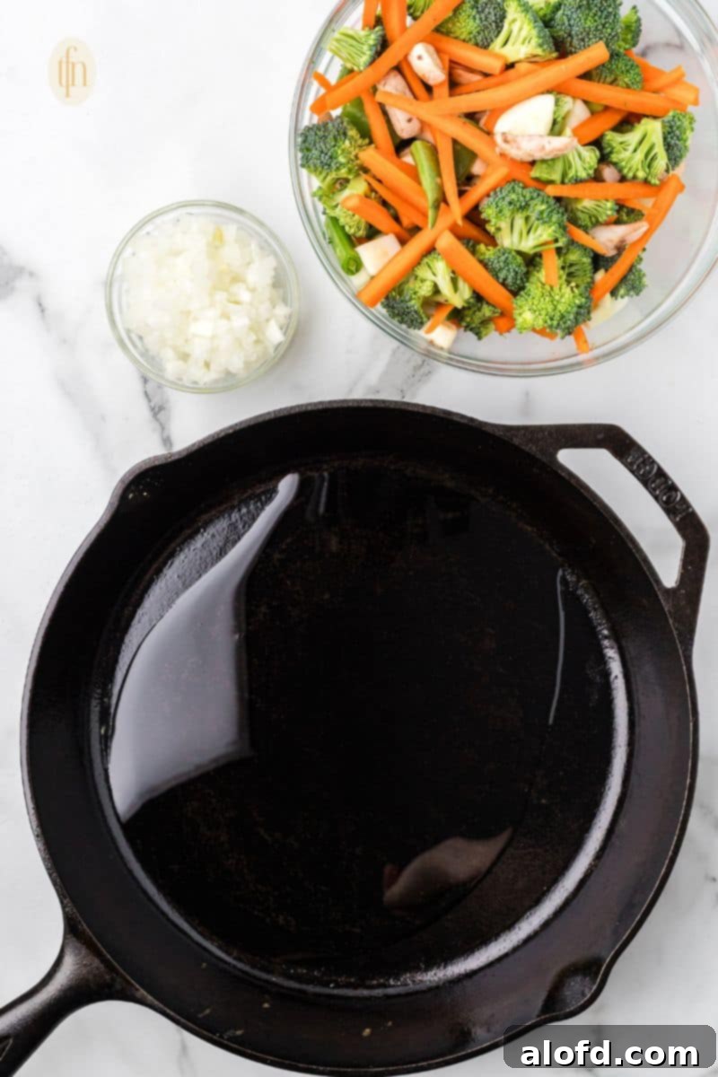 Surf and Turf Fried Rice 7 Chopped vegetables and garlic powder are added to a hot skillet with oil.