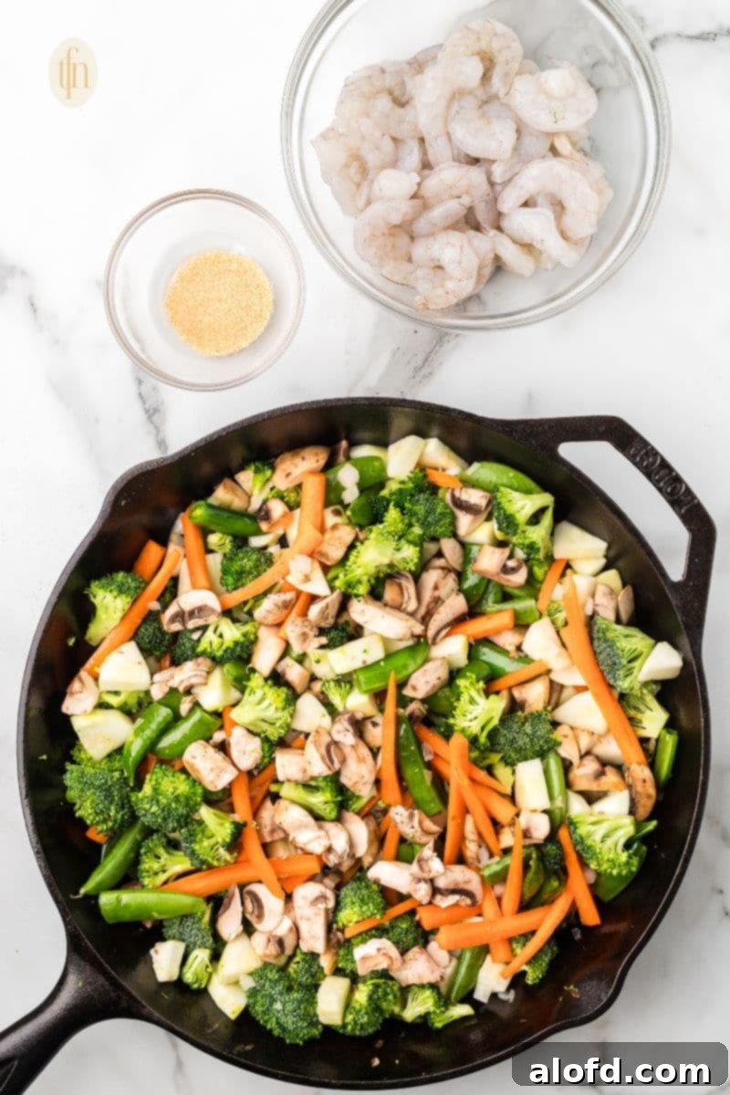 Surf and Turf Fried Rice 9 Creating a well in the cooked ingredients to add butter to the skillet.