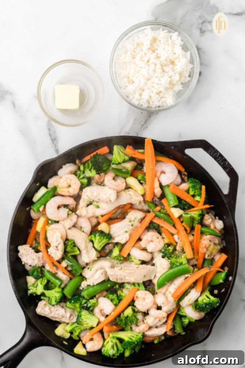 Surf and Turf Fried Rice 10 Adding butter and cooked rice to the well in the center of the skillet.