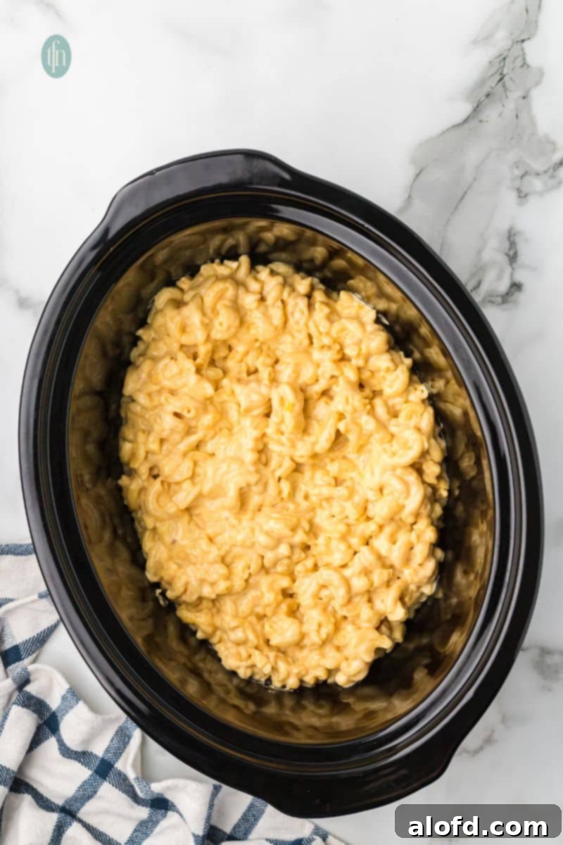 Crockpot filled with ready-to-serve mac and cheese.
