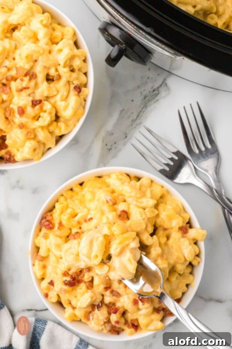 A beautifully presented bowl of creamy mac and cheese, garnished for serving.