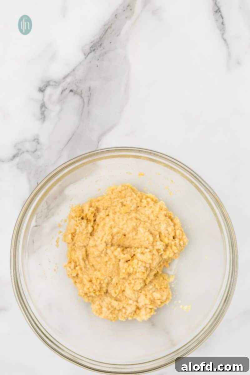 Savory Chicken Meatloaf 9 A large glass bowl holds the milk, egg, and breadcrumb mixture after being combined and allowed to soak.