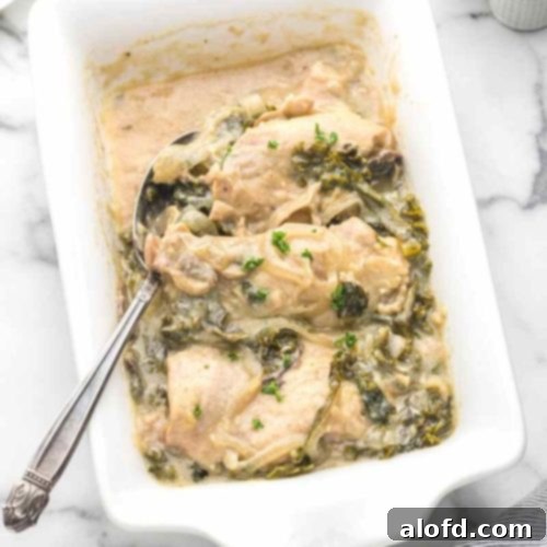 Comforting Crockpot Smothered Chicken 11 A white casserole serving dish with smothered chicken.