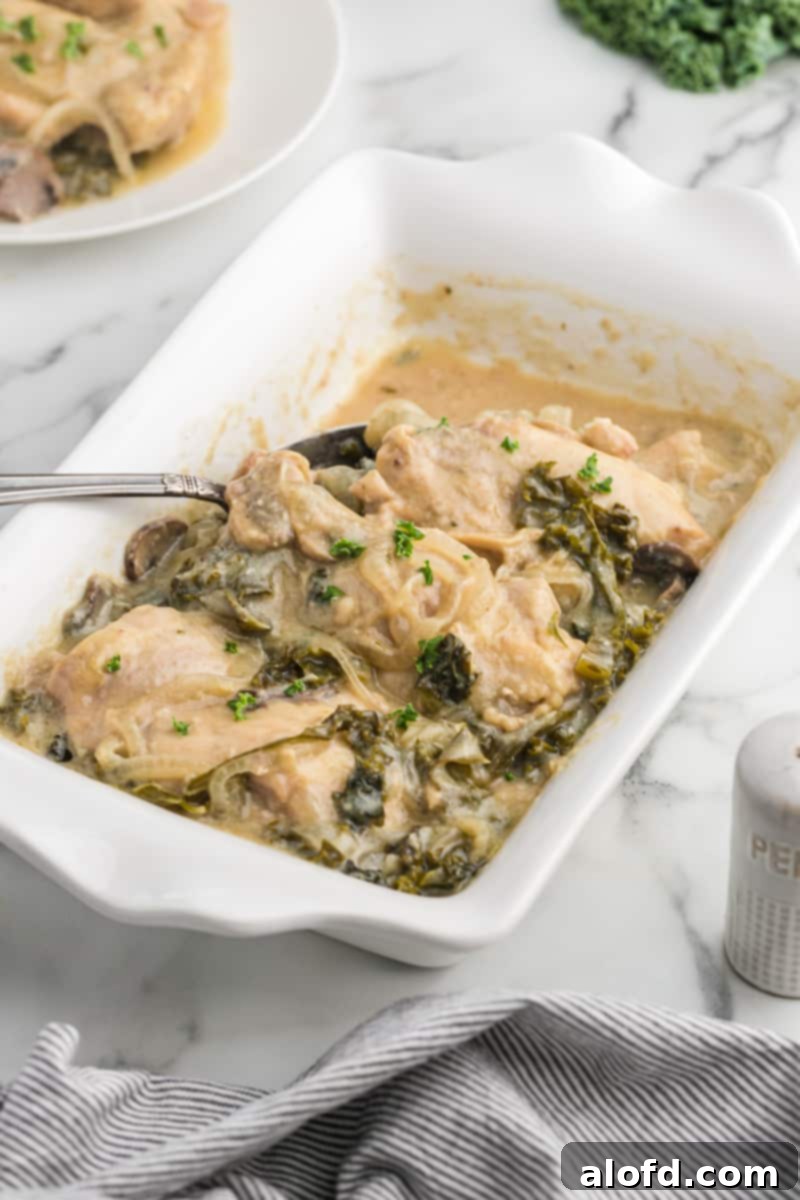 Comforting Crockpot Smothered Chicken 3 Smothered chicken recipe crock pot in a white serving dish with a spoonful of the creamy sauce.