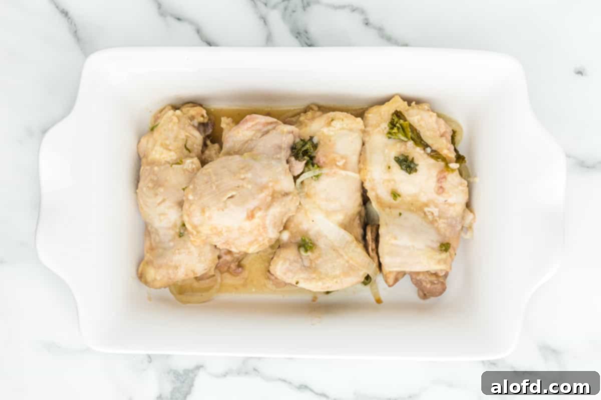 Comforting Crockpot Smothered Chicken 4 A casserole dish of smothered chicken, showcasing the rich, creamy sauce and tender chicken.
