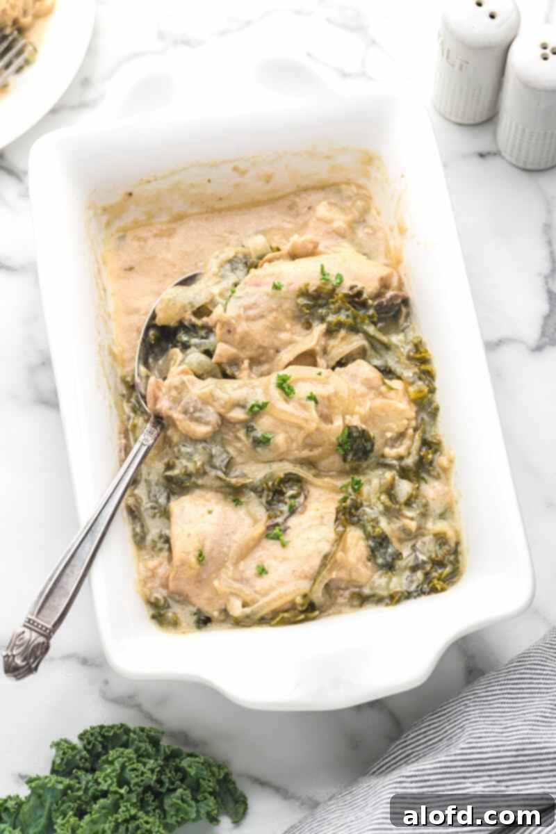 Comforting Crockpot Smothered Chicken 10 A white casserole serving dish with smothered chicken slow cooker, garnished for serving.