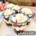 Small cups filled with mini marshmallows and red and blue berries.