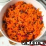 Shredded carrot in a white bowl.