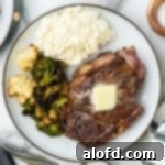 A plate of steak with mashed potatoes and broccoli.