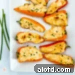 White plate topped with mini stuffed peppers on a white background.