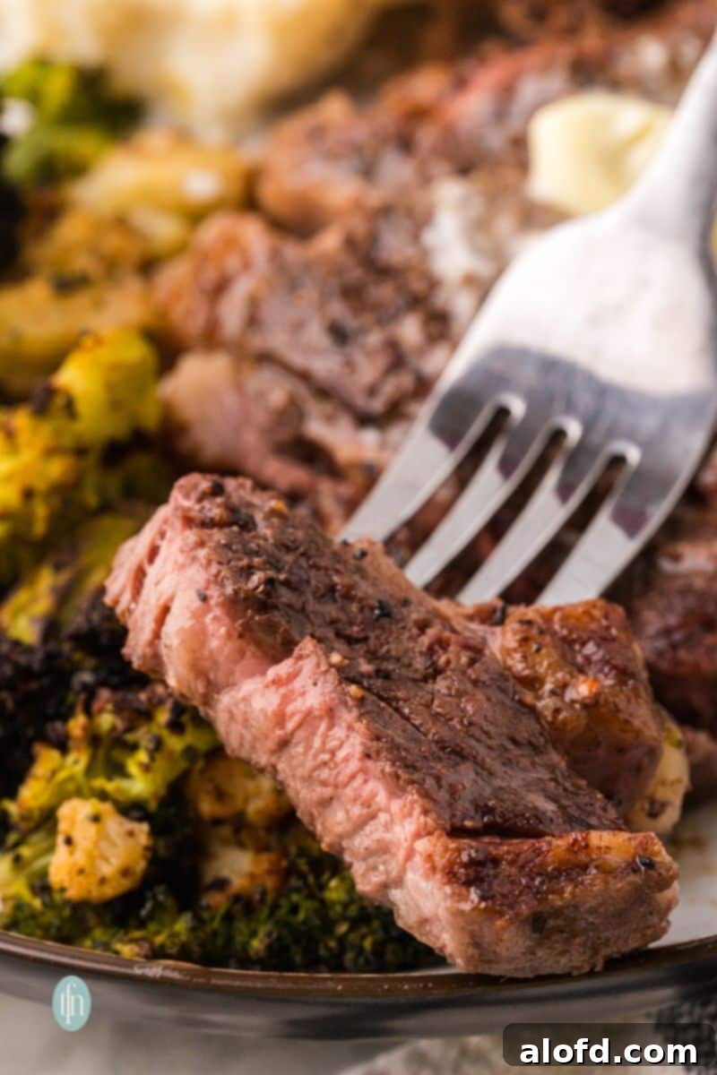 A perfectly cooked plate of chuck eye steak with vibrant broccoli florets as a side.