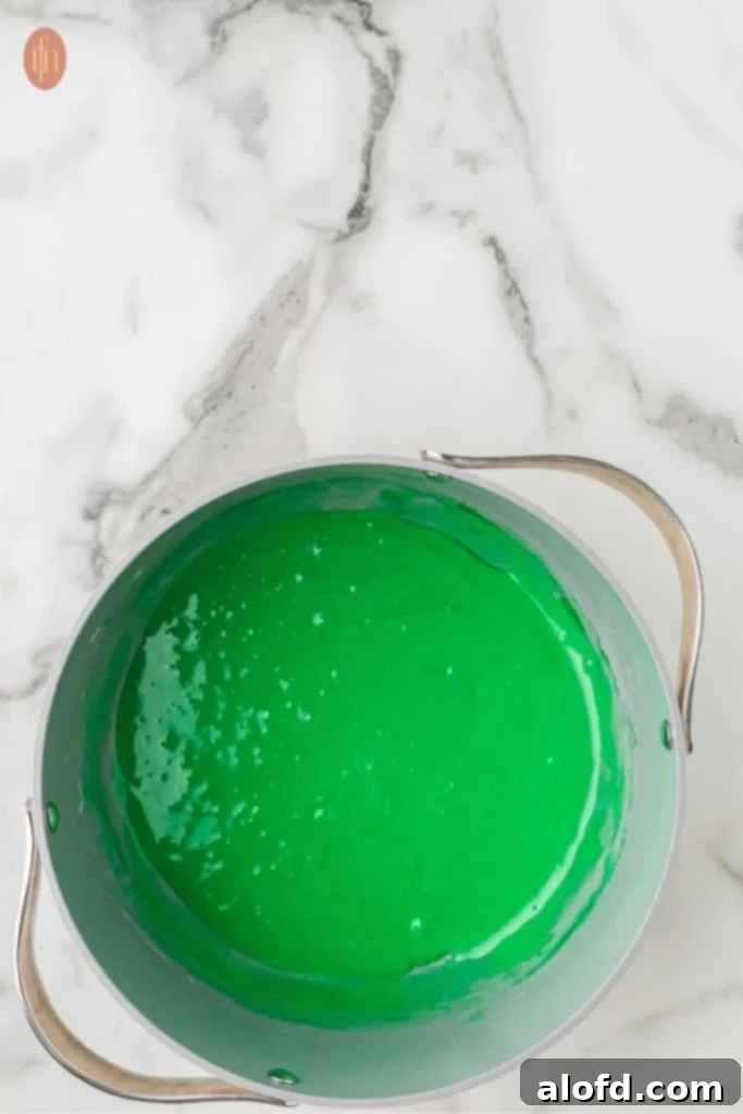Christmas Wreath Cereal Cookies 7 Close-up of the smooth and glossy melted marshmallow mixture with beautiful green food coloring.