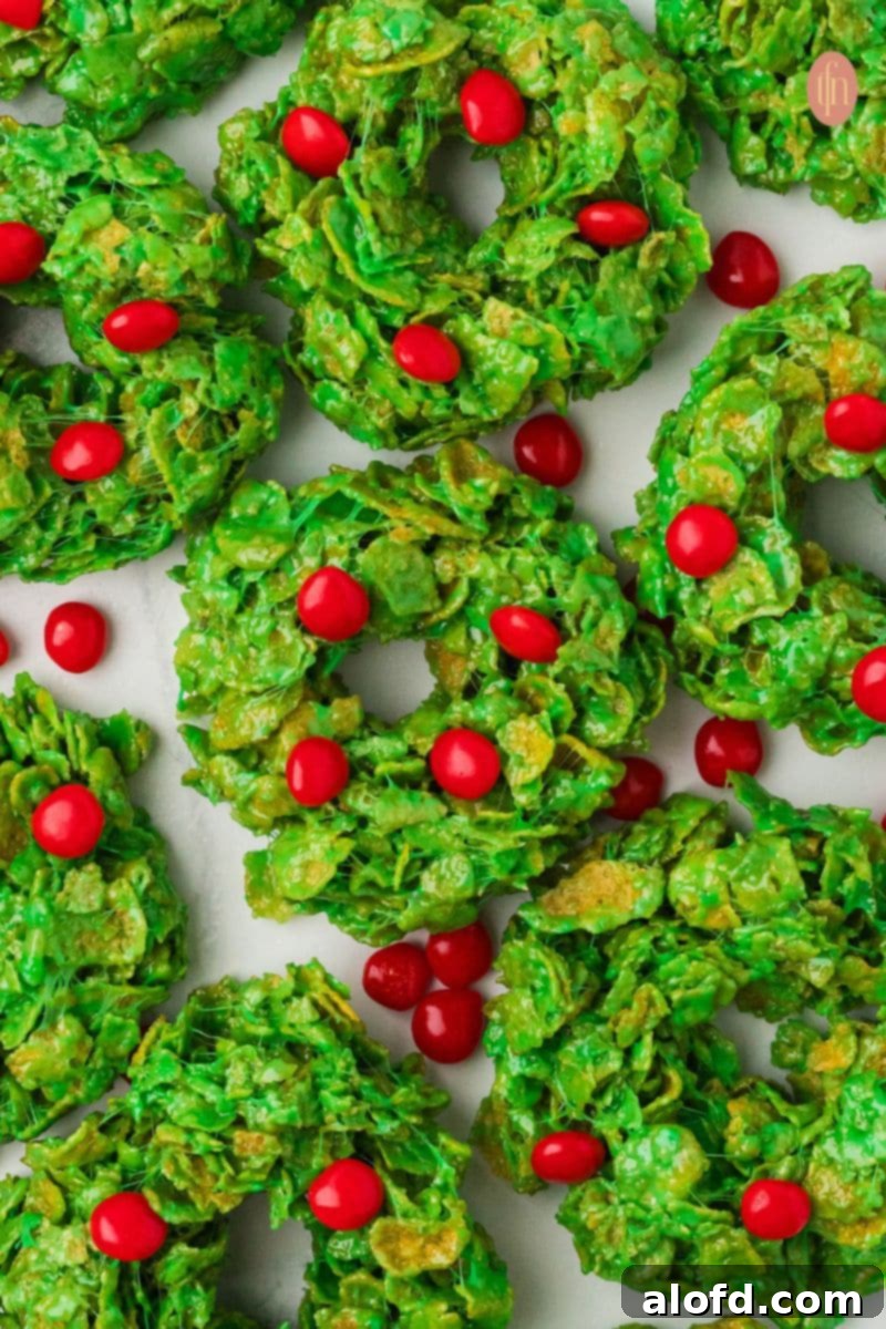 Top 10 Holiday Cookie Delights 2 Cornflake wreath cookies with red cinnamon candies on top, a festive and visually appealing Christmas treat.