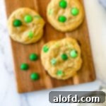 Top 10 Holiday Cookie Delights 11 Green m and m cookies on a wooden serving board.