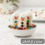 Top 10 Holiday Cookie Delights 3 Close-up of decorated Nutter Butter snowman cookies in a bowl of M&M candies.
