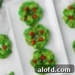 Top 10 Holiday Cookie Delights 7 Plate of cornflake wreath cookies with red cinnamon candies.