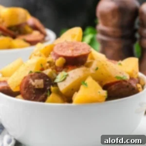 Slow-Cooker Sausage and Potato Delight 15 Crockpot Sausage Potatoes stacked high with ingredients.