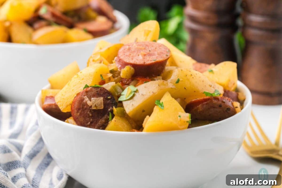 Slow-Cooker Sausage and Potato Delight 3 Bowl of slow-cooked sausage and potatoes.