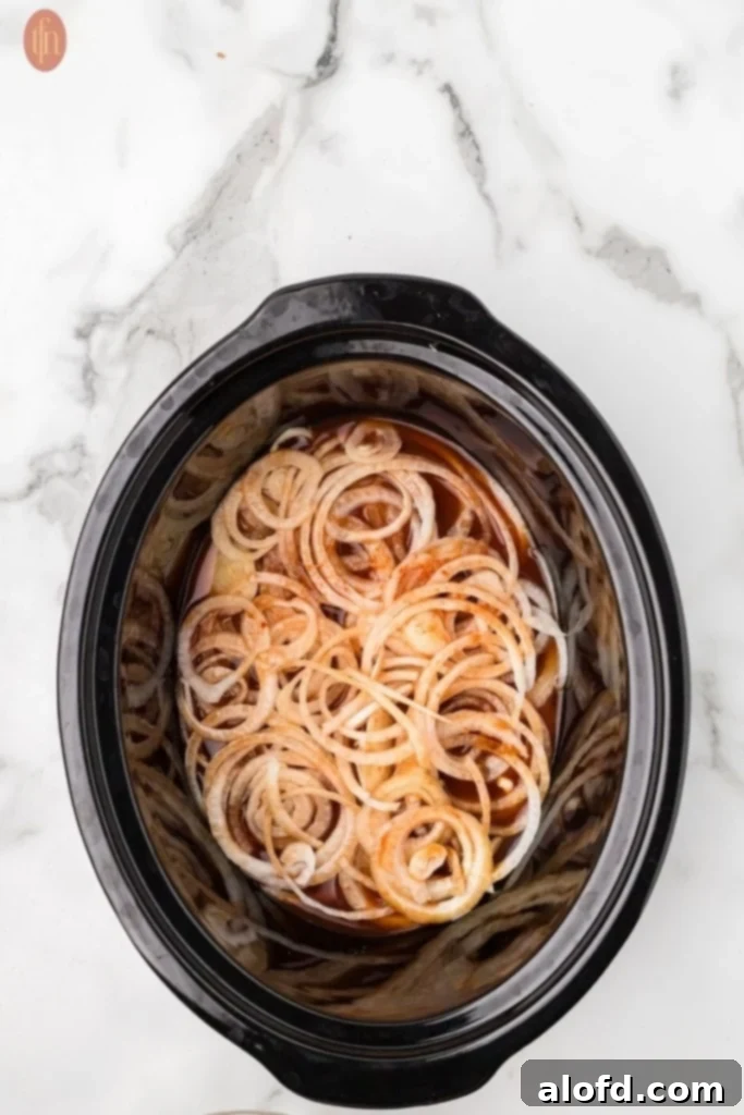 Crockpot with liquid and onions