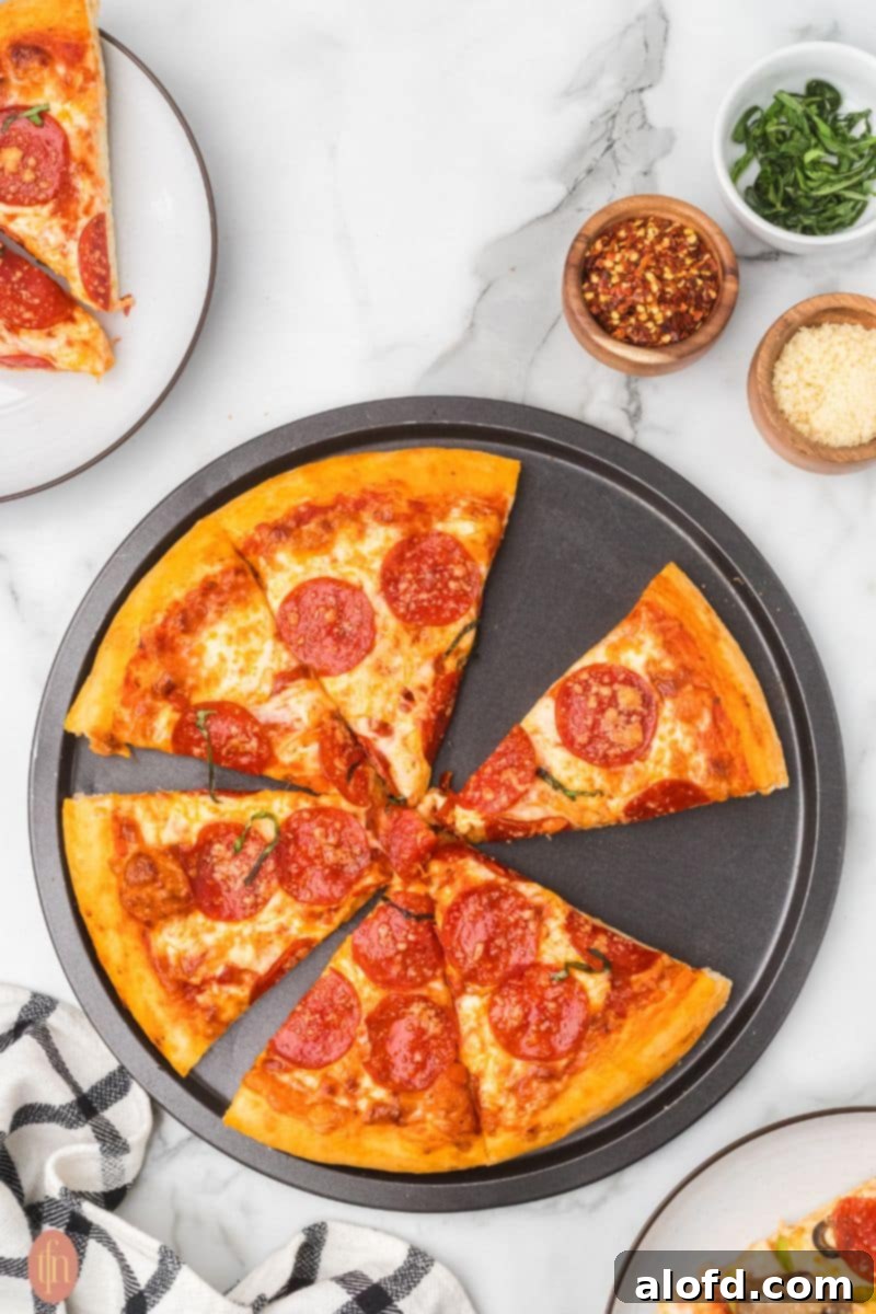 Homemade Pizza with a Crust Made from Scratch 12 Slices of homemade pizza on a pan.