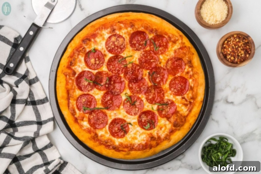 Homemade Pizza with a Crust Made from Scratch 13 Homemade pizza served in a round pan.