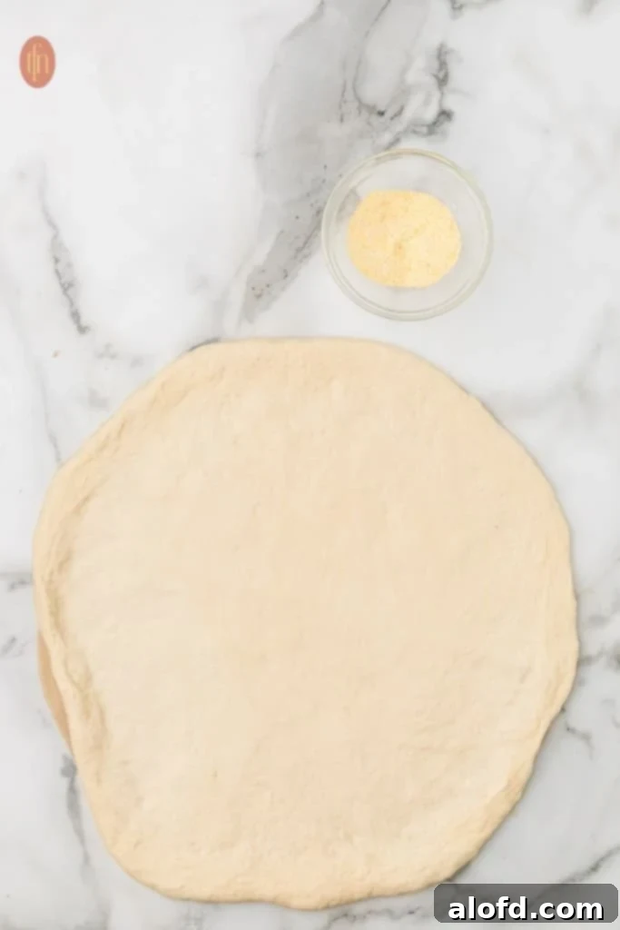 Homemade Pizza with a Crust Made from Scratch 6 Pizza dough and cornmeal.