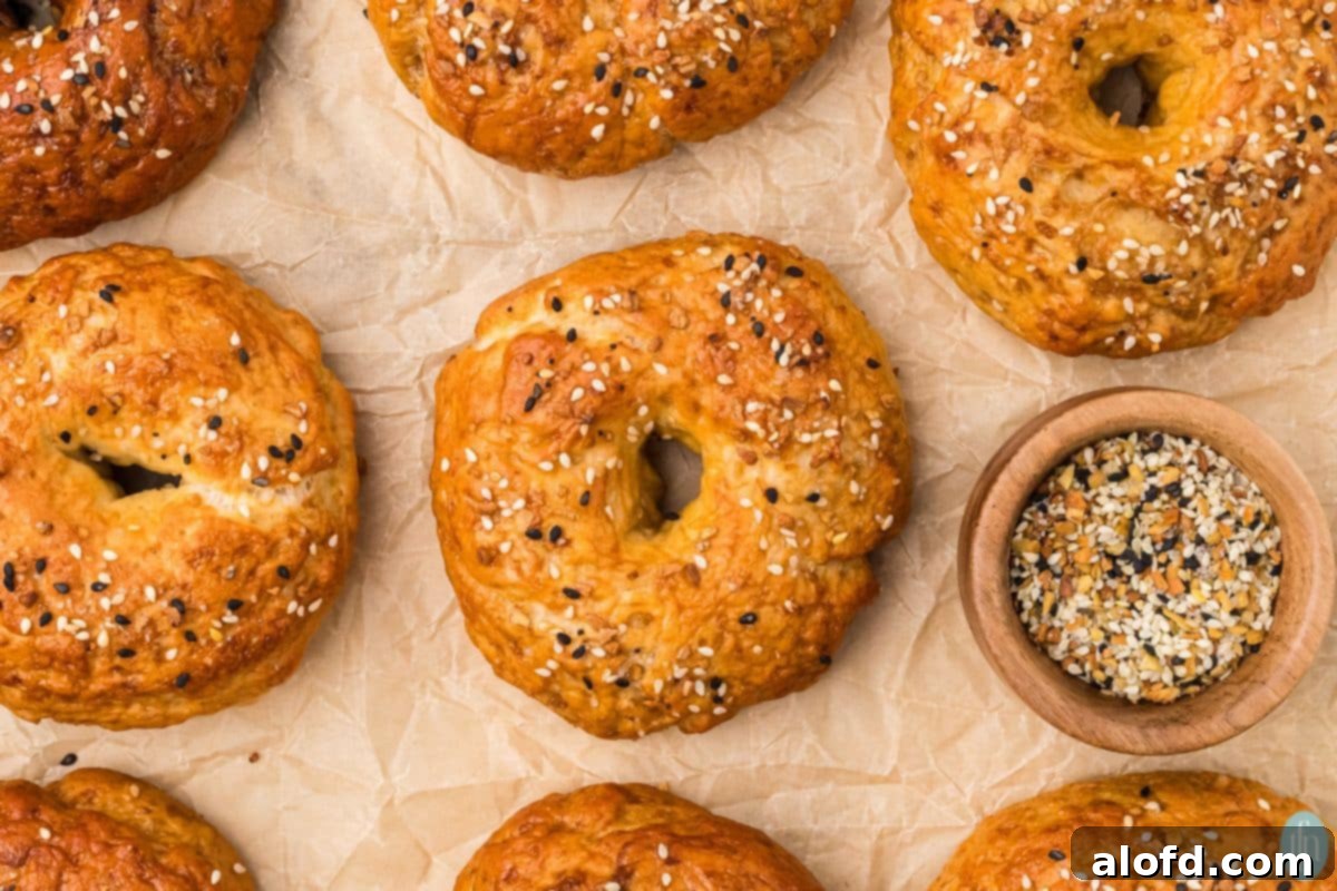 Sourdough Bagels Artisan Sourdough Bagels 3 Sourdough bagels on parchment paper with everything bagel seasoning.