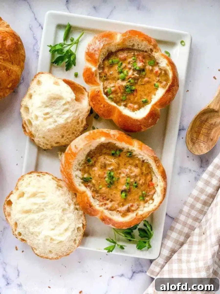 Pumpkin-Shaped Bread Bowls filled with soup, perfect for fall.