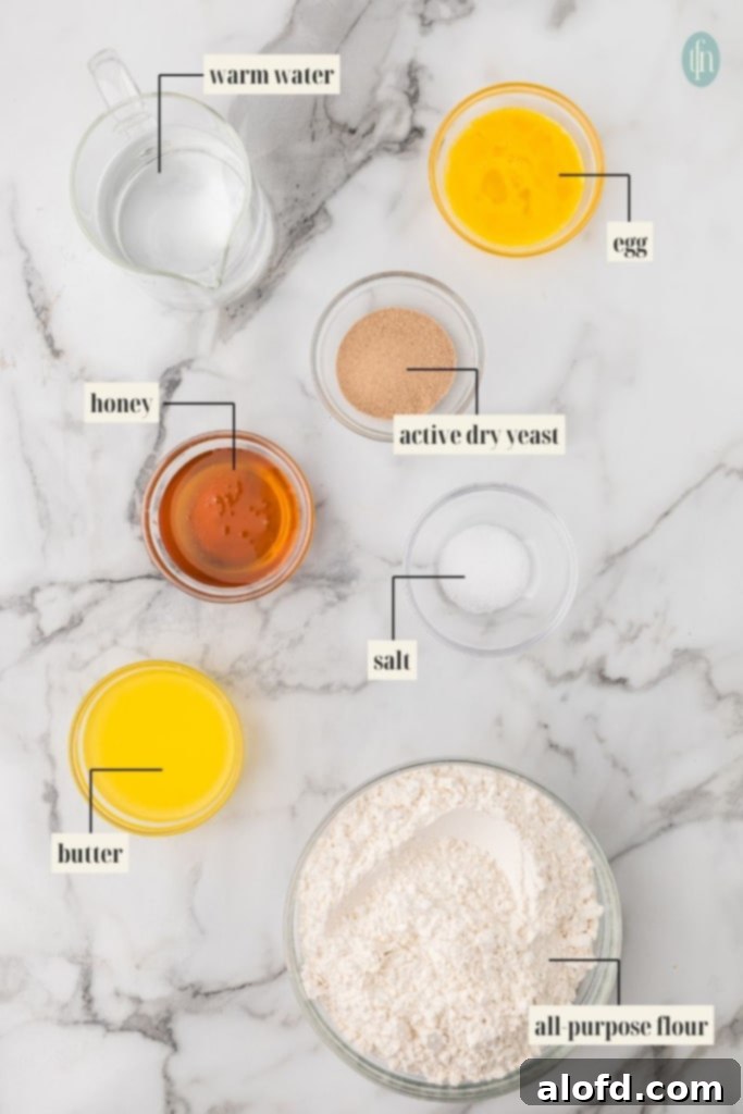 Quick Dinner Rolls 4 Ingredients for quick dinner rolls: warm water, egg, honey, active dry yeast, salt, butter, and all-purpose flour.