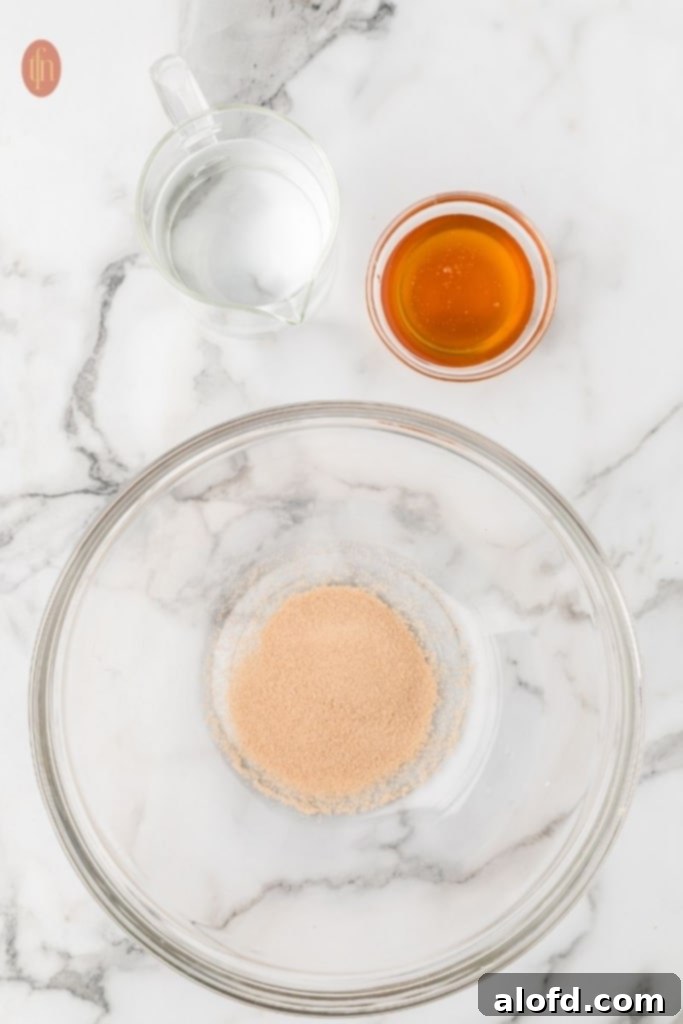 Quick Dinner Rolls 5 A bowl of honey, active dry yeast, and warm water.
