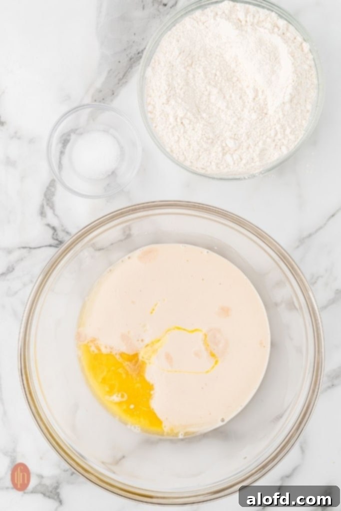 Quick Dinner Rolls 7 Three glass bowls of ingredients for dinner rolls.