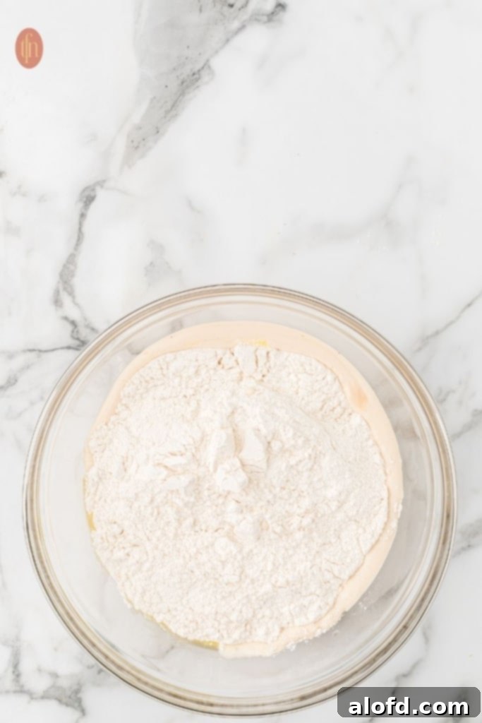 Quick Dinner Rolls 8 A bowl of all-purpose flour and other ingredients for dinner rolls.