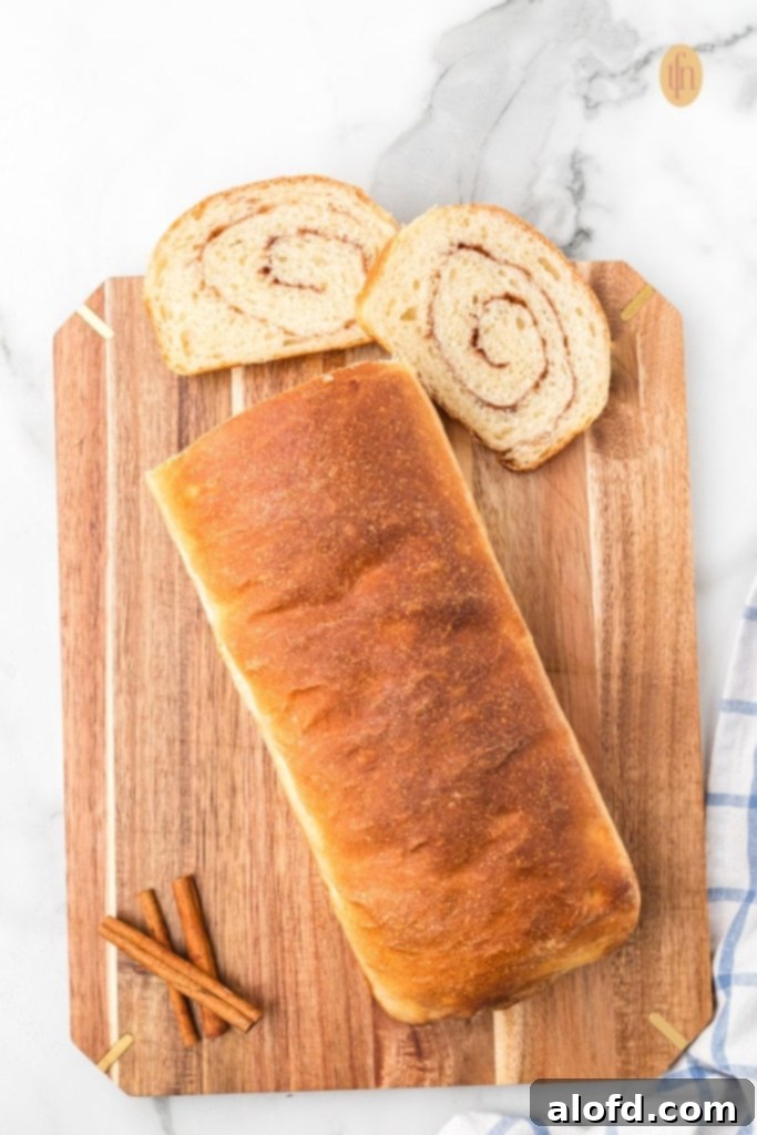 Choosing the Right Flour for Your Baking Project 2 Freshly baked cinnamon raisin sourdough bread on a wooden board with cinnamon sticks.