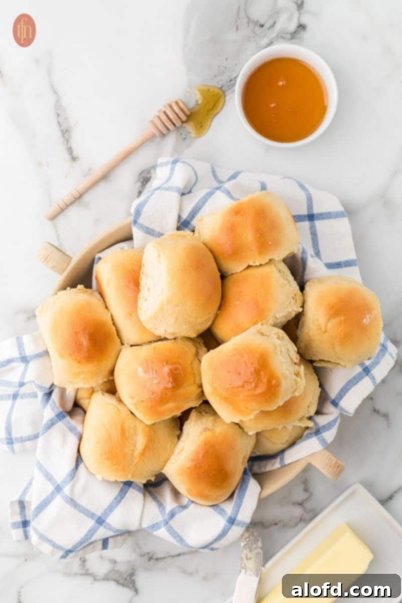 Choosing the Right Flour for Your Baking Project 5 A wooden bowl filled with golden brown, freshly baked dinner rolls.